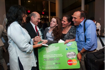 Mel Vera receiving the NFTE NY Metro Business Plan Competition winning check for Vera Natural